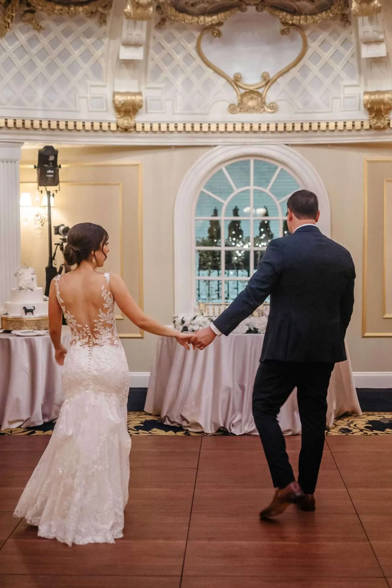 bride and groom holding hands at the dome room 