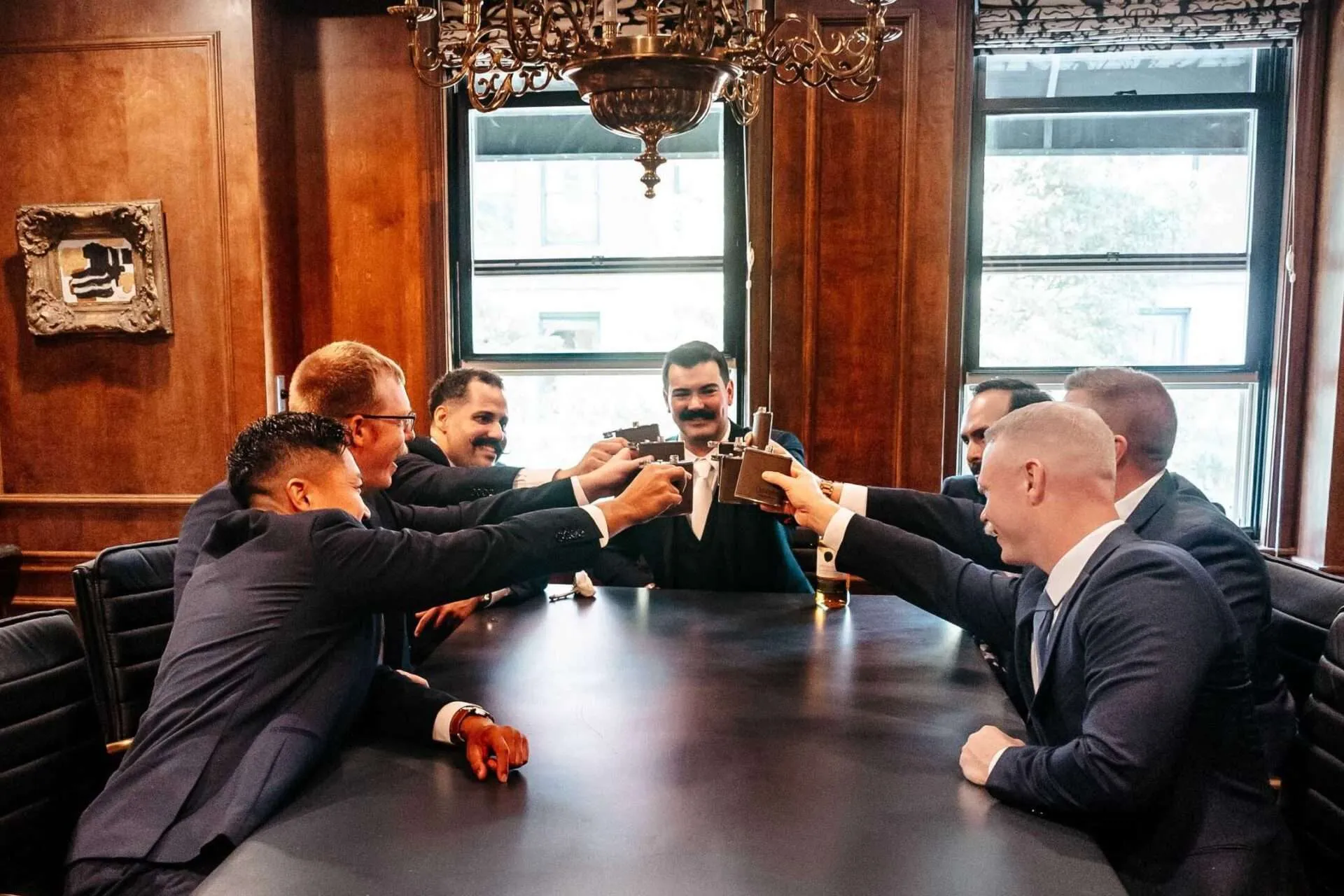groomsmen making a toast with the groom at the lenox hotel