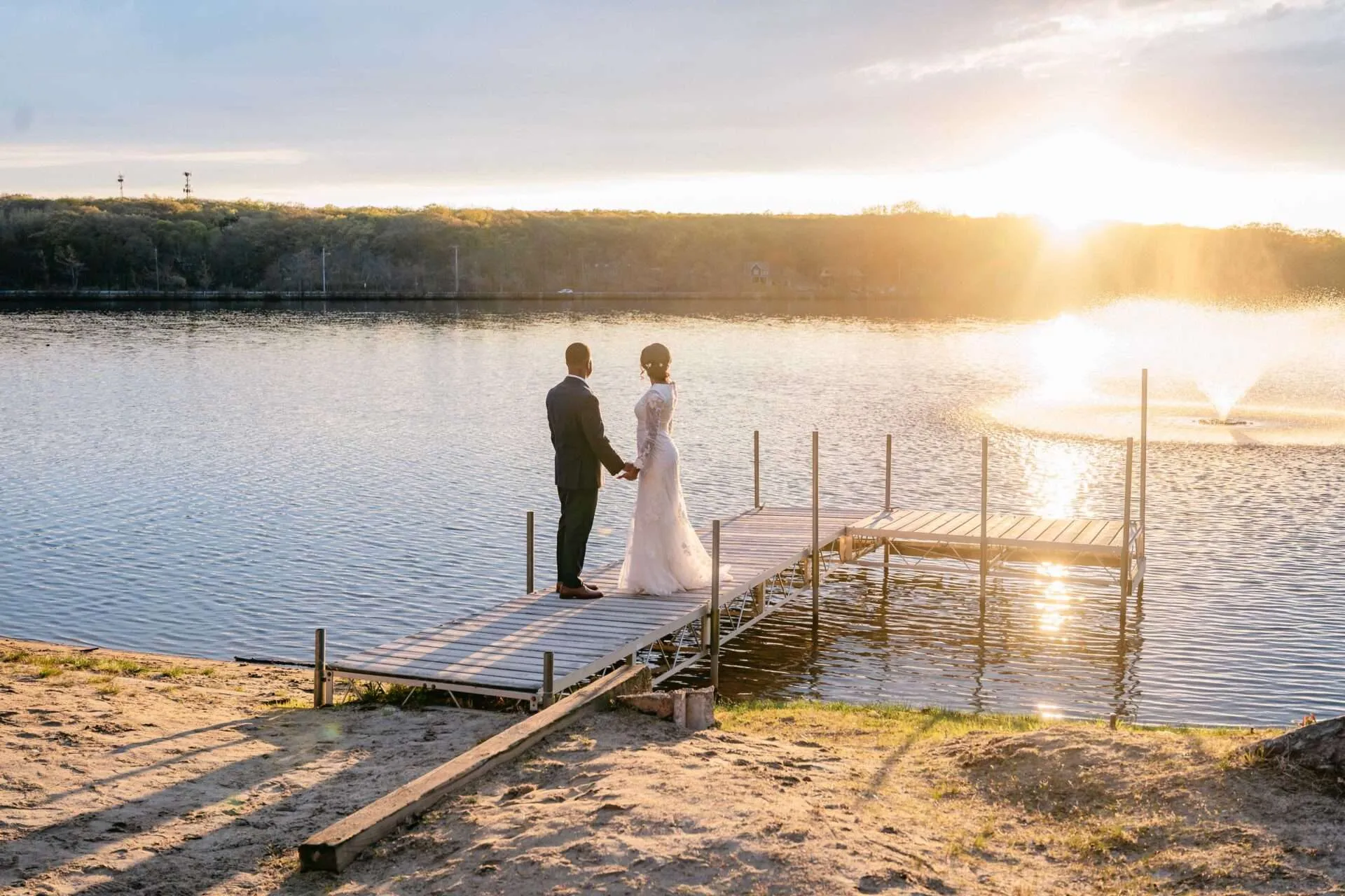 bride and groom at doc overlooking sunset