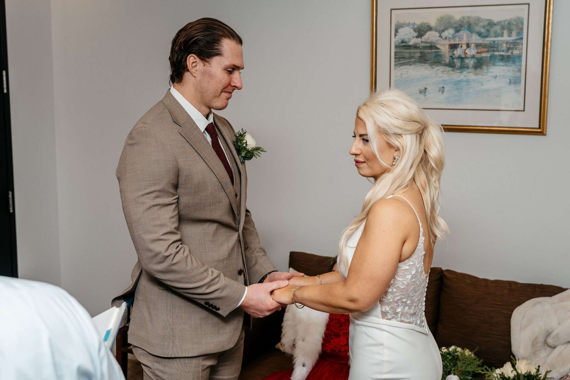 Bride and groom smile and listen to the officiant while they are getting married at Boston city hall