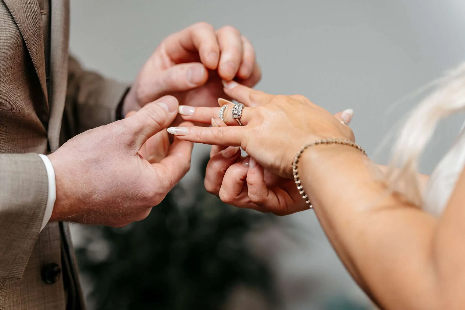 Bride and groom exchange wedding bands after learning how to get married at Boston city hall