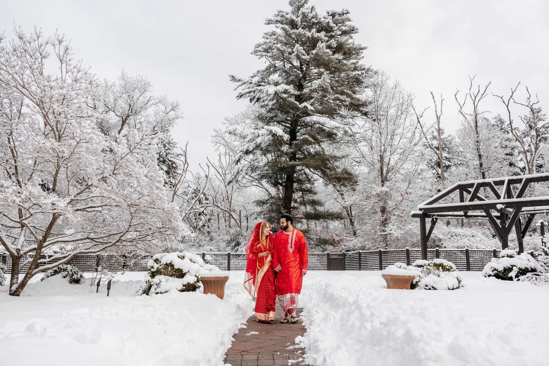 bride and groom walking in the snow