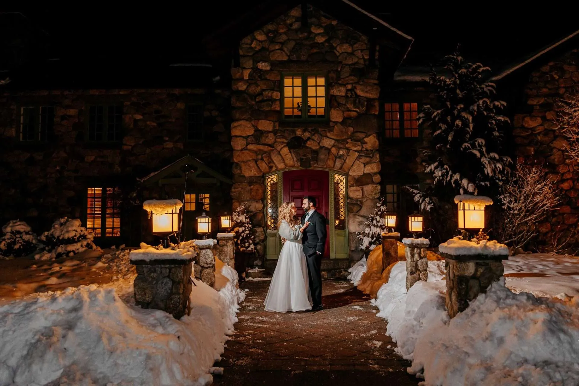 couple standing outside taking wedding day pictures