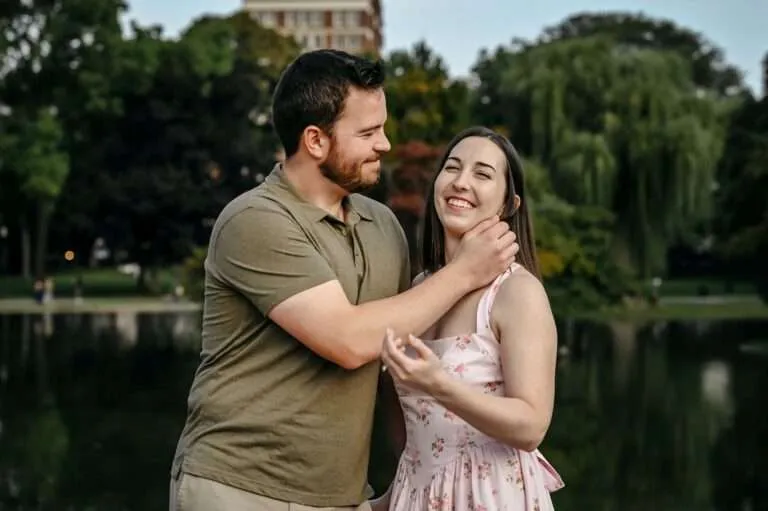 Couple laughing together beside the lagoon in the Boston Public Garden