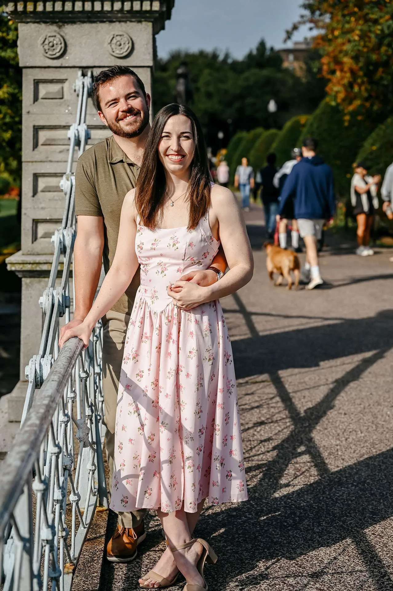 A couple holds hands on a bridge knowing what date night restaurants in boston are the best.
