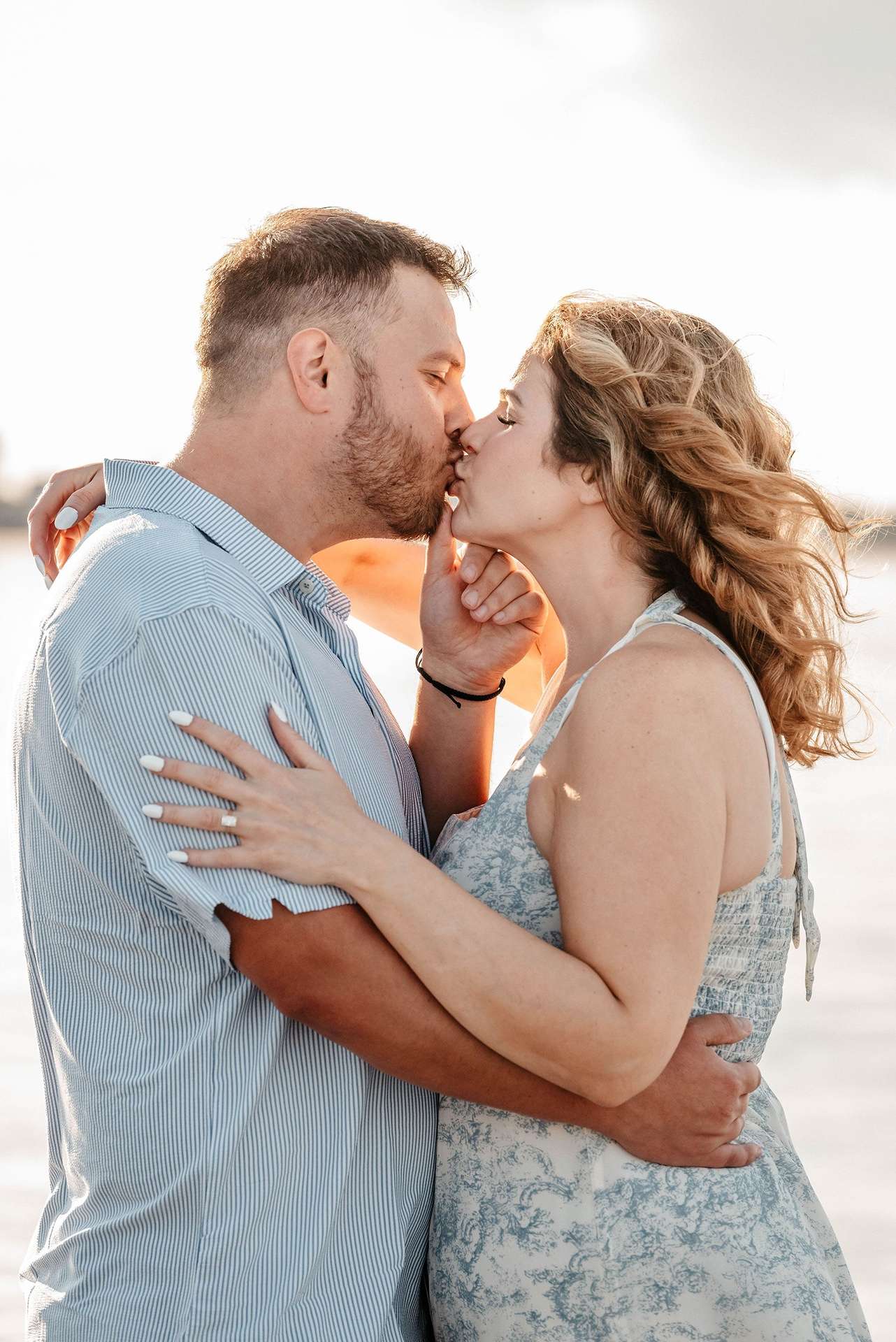 Some of the best date ideas in boston include a man proposing on the beach and sharing a kiss with his new fiance.