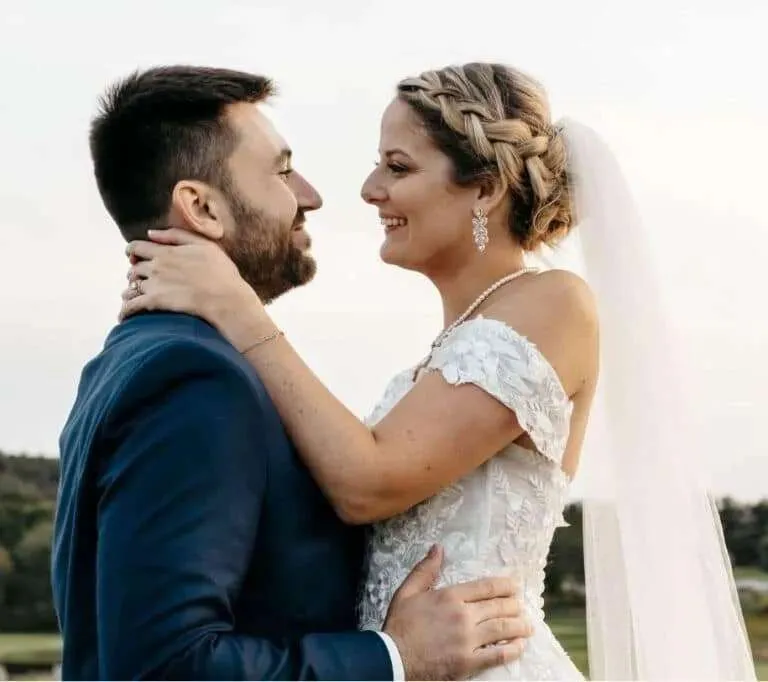 Bride and groom embracing face to face at golden hour in Vermont